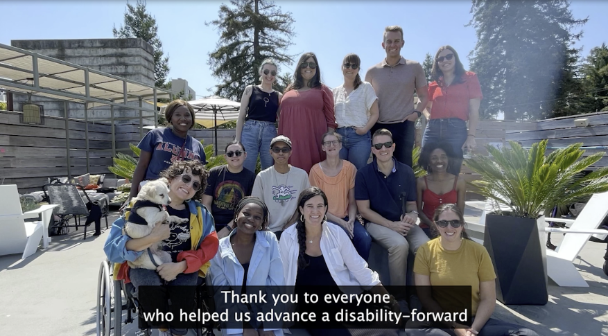 The Kelsey team, people of various races, with and without disabilities, is pictured together on a patio.